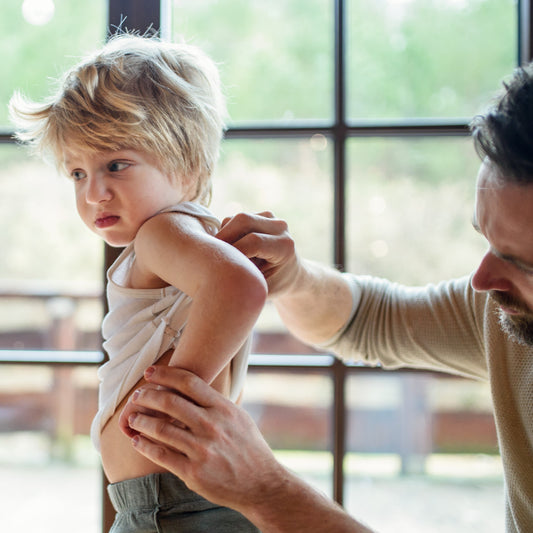 A dad checking kid's back