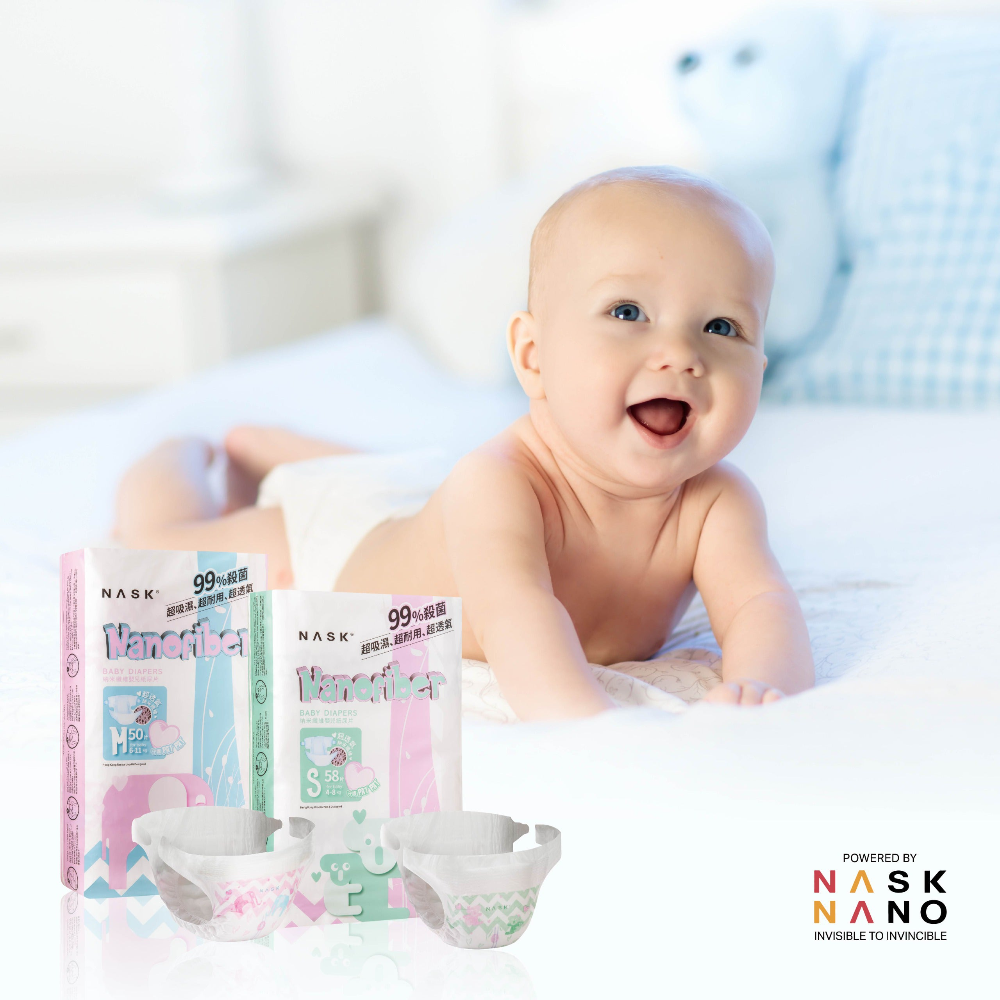 baby on the bed_with_nask diapers_at_side